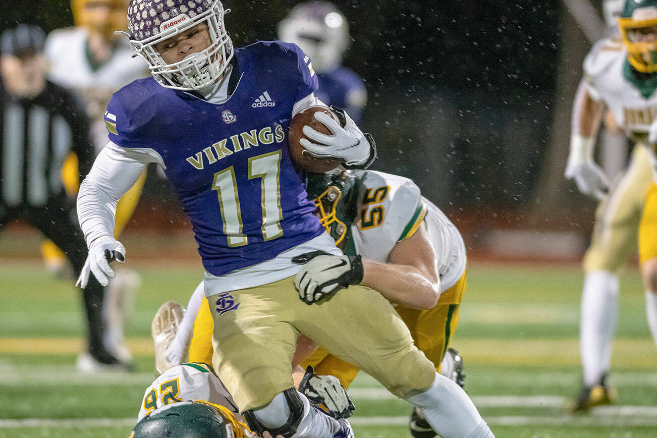 Lake Stevens running back Jayden Limar carries the ball with two Richland defenders trying to bring him down during a 4A state playoff game on Saturday, Nov. 13, 2021 in Lake Stevens. (John Gardner / Pro Action Image)
