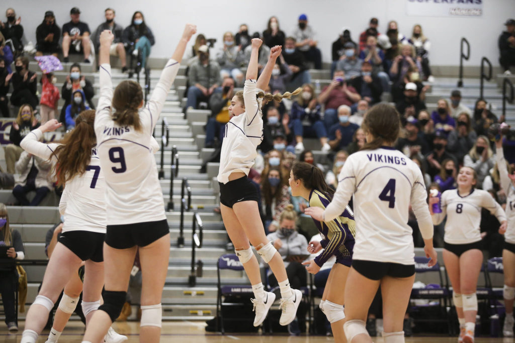 Lake Stevens cheer after a point in the first game as the Vikings beat Mount Si in five sets in a Class 4A Wes-King Bi-District tournament semifinal volleyball matchup on Tuesday, Nov. 9, 2021 in Lake Stevens, Washington. (Andy Bronson / The Herald)
