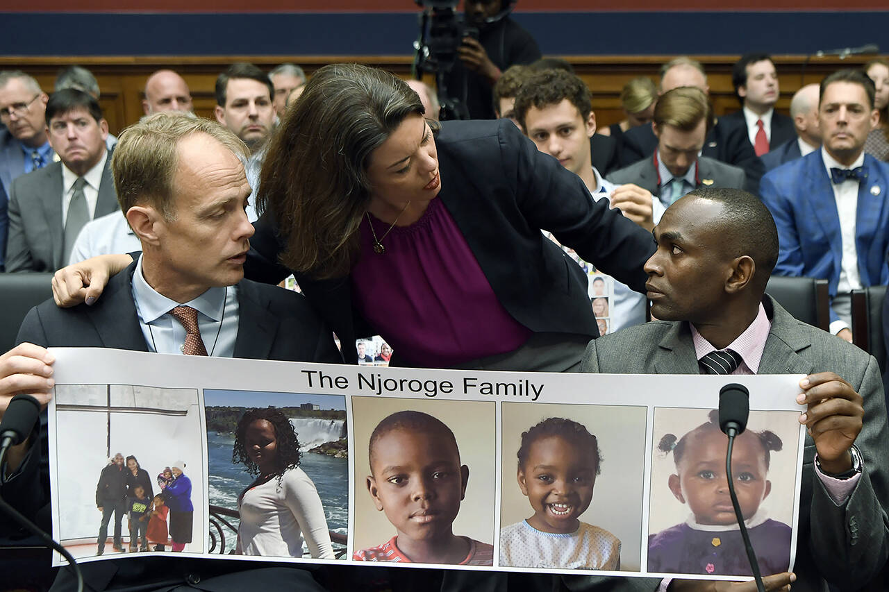 In this July 2019 photo, Rep. Angie Craig, D-Minn. (center), talks with Paul Njoroge (right), who lost his wife and three young children in the March 2019 crash of an Ethiopian Airlines Boeing 737 Max airplane, as Michael Stumo (left), who lost his daughter in the crash, looks on before the start of a House Transportation subcommittee hearing on aviation safety on Capitol Hill in Washington. (AP Photo/Susan Walsh, File)