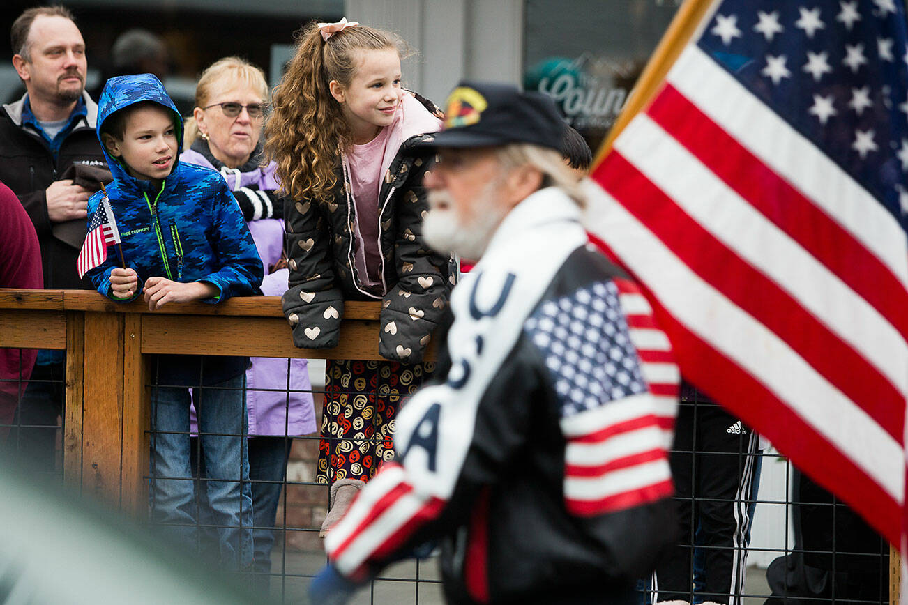 Children watch the Veterans Day Parade as it makes its way down Olympic Avenue on Thursday, Nov. 11, 2021 in Arlington, Wa. (Olivia Vanni / The Herald)