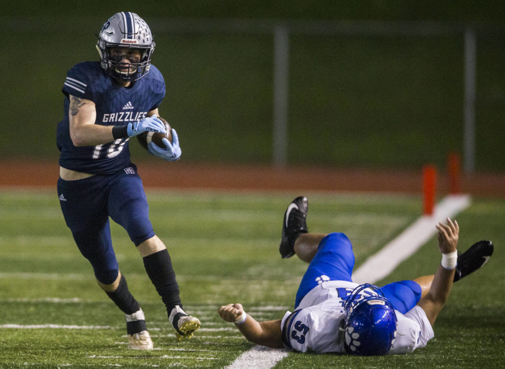 Glacier Peak’s Ryan King shakes a tackle by Bothell’s Saivon Soeum and runs down the sideline during the game on Friday, Nov. 12, 2021 in Snohomish, Wa. (Olivia Vanni / The Herald) 
