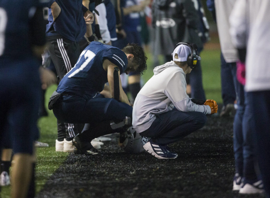 Glacier Peak’s Joe Johnson and a coach react to losing to Bothell and being knocked out of the playoffs on Friday, Nov. 12, 2021 in Snohomish, Wa. (Olivia Vanni / The Herald)
