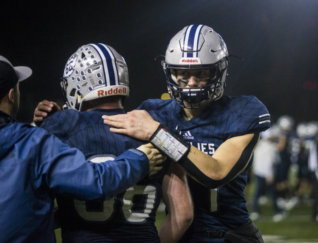 Glacier Peak’s Logan Szarzec comforts his teammate after losing to Bothell on Friday, Nov. 12, 2021 in Snohomish, Wa. (Olivia Vanni / The Herald)
