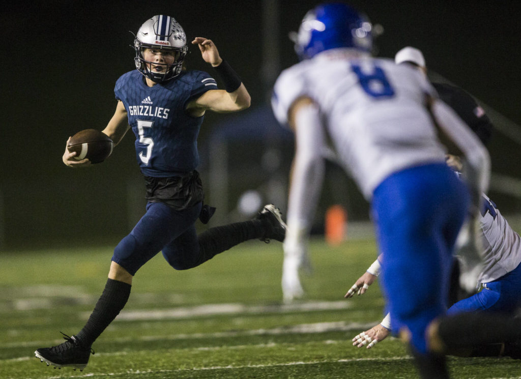 Glacier Peak’s River Lien escapes a tackle and looks for a teammate to pass to during the game against Bothell on Friday, Nov. 12, 2021 in Snohomish, Wa. (Olivia Vanni / The Herald)
