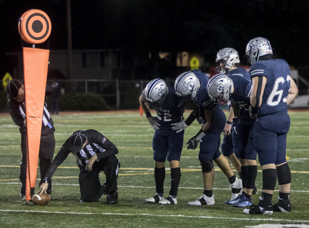 Glacier Peak players look closely as the referees measure the spot of the ball to see if Bothell made a first down during the game on Friday, Nov. 12, 2021 in Snohomish, Wa. (Olivia Vanni / The Herald)
