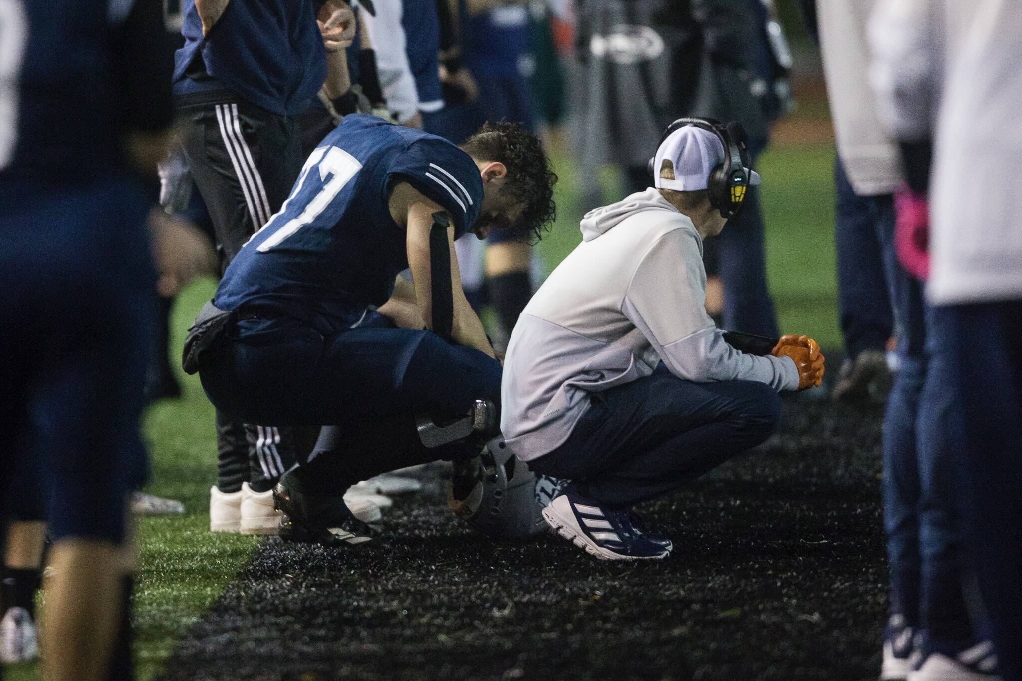 Glacier Peak's Joe Johnson and a coach react to losing to Bothell and being knocked out of the playoffs on Friday, Nov. 12, 2021 in Snohomish, Wa. (Olivia Vanni / The Herald)