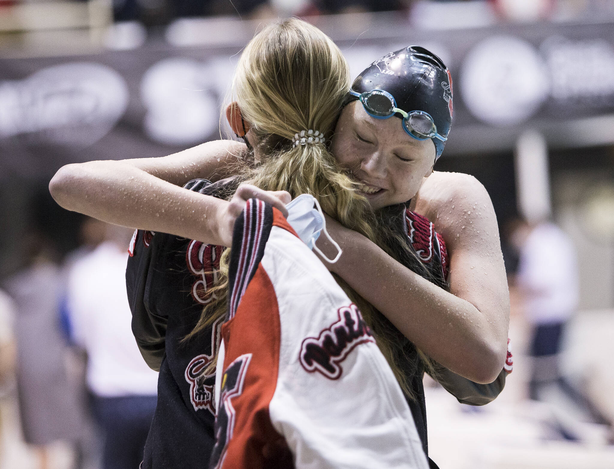 Snohomish sophomore Mary Clarke is congratulated after winning a Class 3A state title in the 50-yard freestyle during the girls swim and dive state championships Saturday in Federal Way. (Olivia Vanni / The Herald)