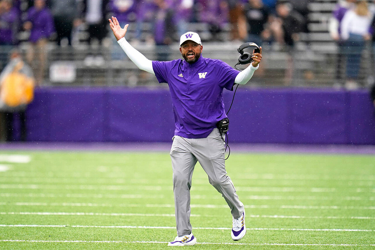 Washington head coach Jimmy Lake walks on the field as he reacts to a call in favor of Arkansas State during a game Sept. 18 in Seattle. (Elaine Thompson / Associated Press)