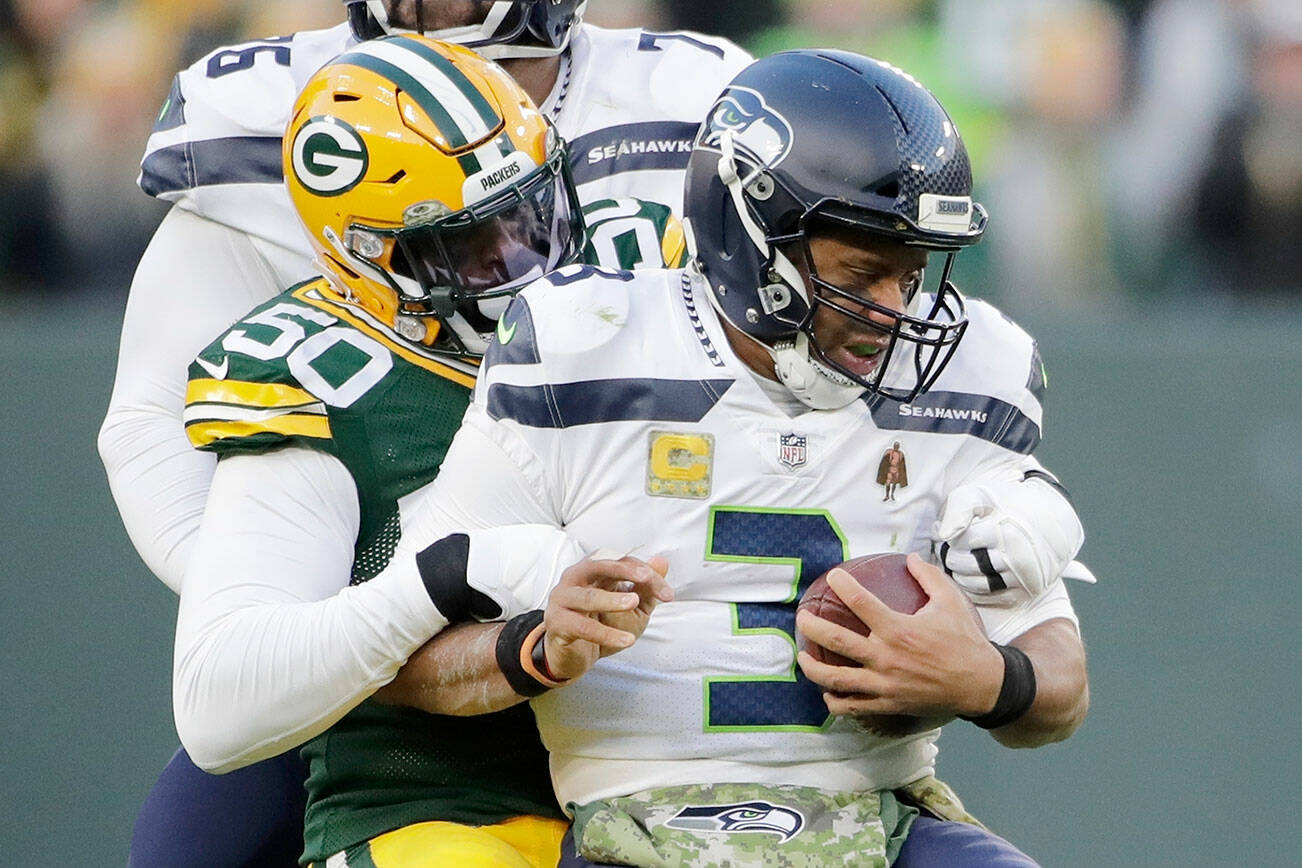 Green Bay Packers' Whitney Mercilus sacks Seattle Seahawks' Russell Wilson during the first half of an NFL football game Sunday, Nov. 14, 2021, in Green Bay, Wis. (AP Photo/Aaron Gash)