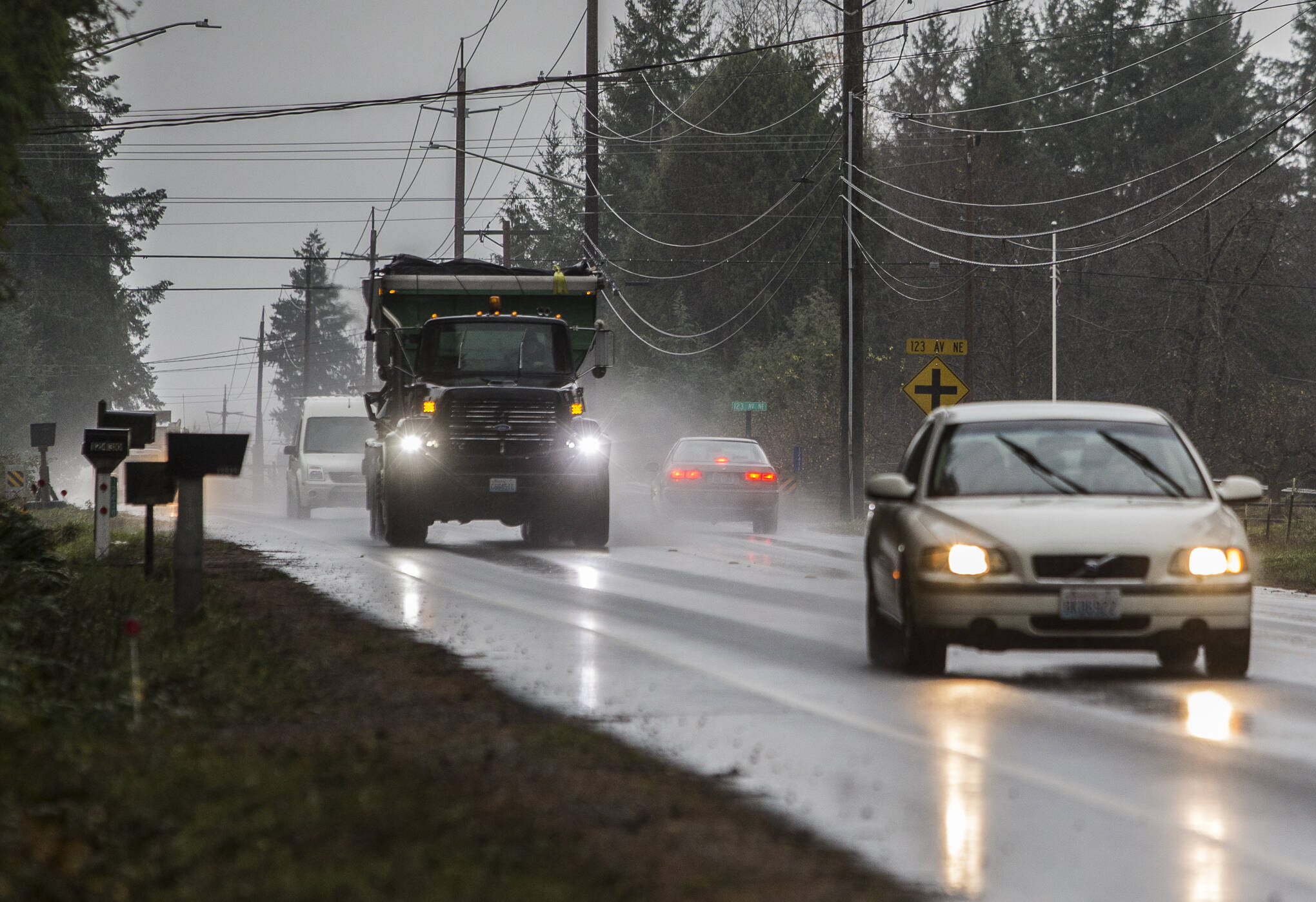 A car brakes and waits for traffic to pass before turning onto 123rd Avenue NE in Lake Stevens. Snohomish County is working on traffic improvements along 84th Street NE there and at another intersection. (Olivia Vanni / The Herald)