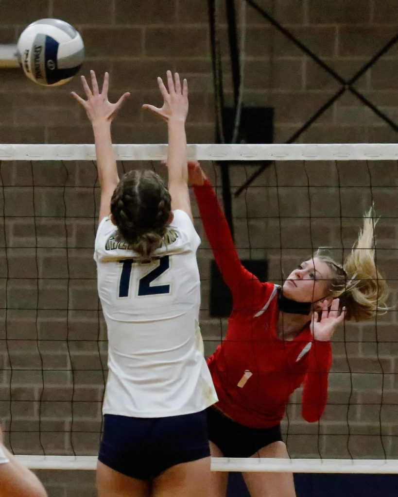 Snohomish’s Kelsey Nichols sends the ball past Arlington’s Ellie Salstrom during a match on Sept. 29 in Arlington. (Kevin Clark / The Herald)
