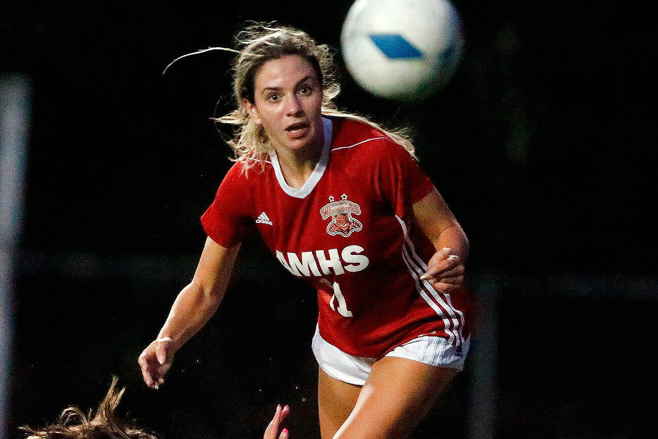 Arlington's Maddy Stivers kicks the ball loose from Archbishop Murphy's Taylor Campbell at Archbishop Murphy High School Tuesday night in Everett on September 14, 2021. The Wildcats won 6-1. (Kevin Clark / The Herald)