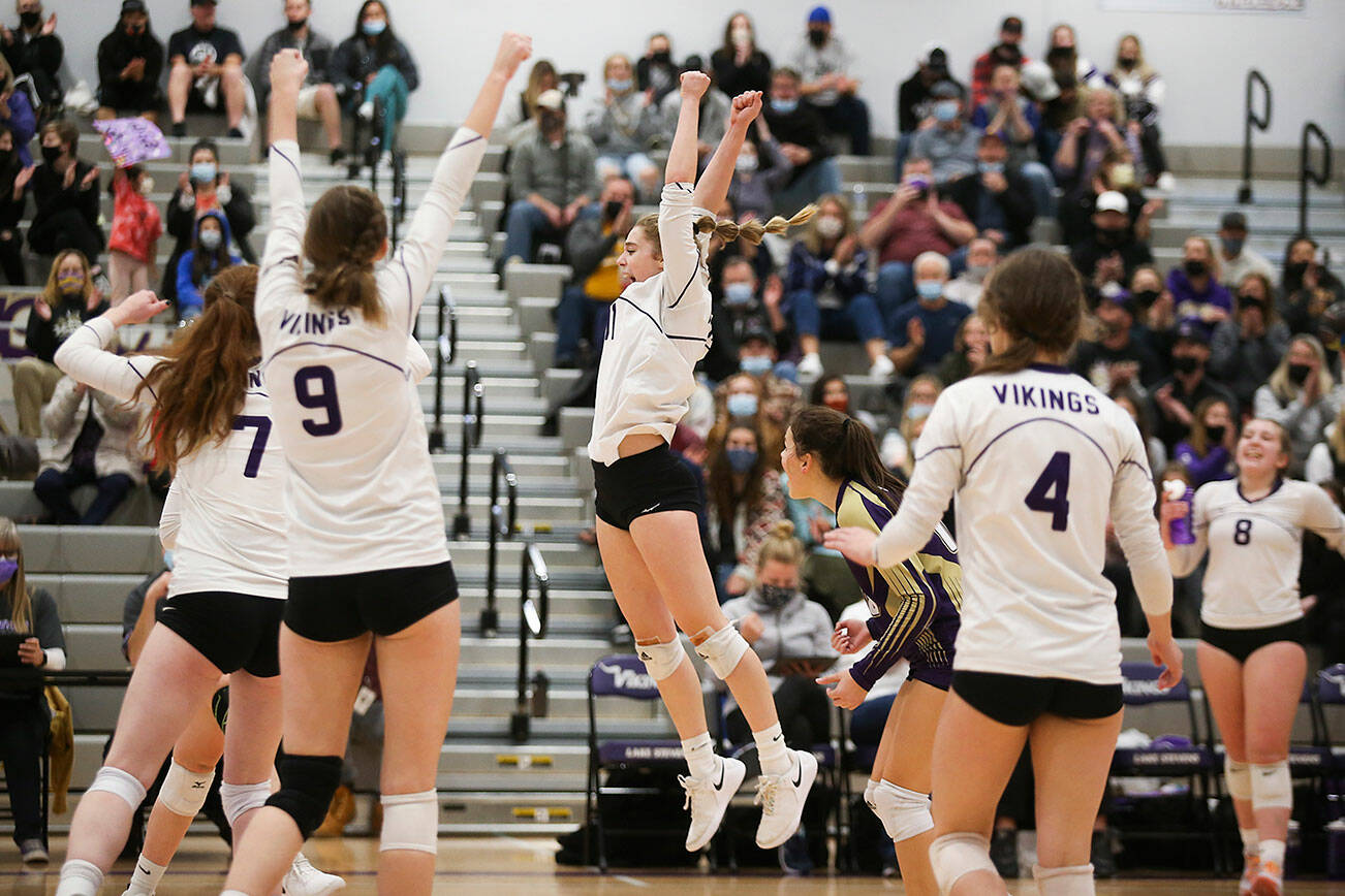 Lake Stevens cheer after a point in the first game as the Vikings beat Mount Si in five sets in a Class 4A Wes-King Bi-District tournament semifinal volleyball matchup on Tuesday, Nov. 9, 2021 in Lake Stevens, Washington.  (Andy Bronson / The Herald)