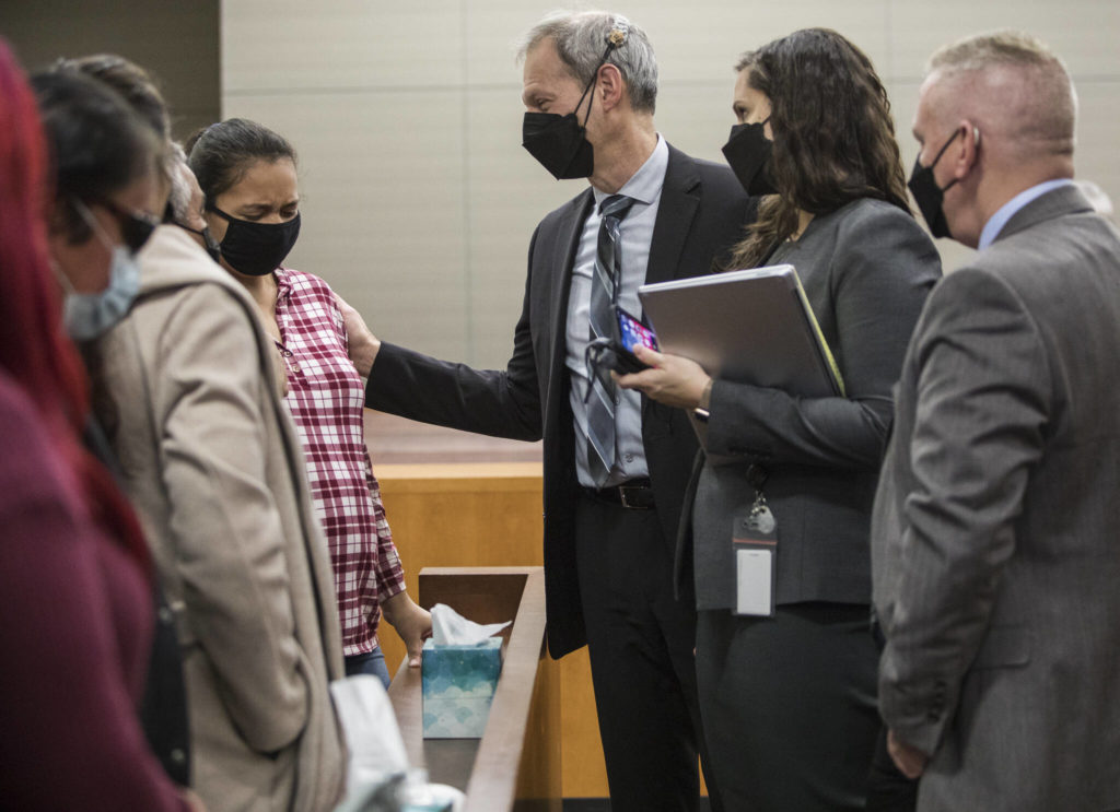 Algeria Canales, a sister of Alisha Canales-McGuire, becomes emotional while speaking with deputy prosecutor Jarett Goodkin, after the jury found Kevin Lewis guilty of first-degree murder Thursday in Everett. (Olivia Vanni / The Herald)
