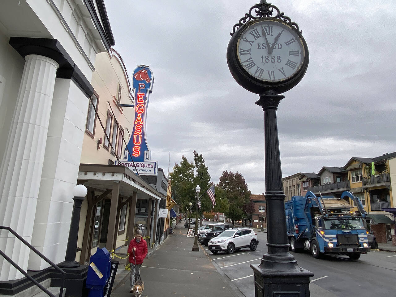 A woman walks a dog in downtown Snohomish on Oct. 22. (Sue Misao / The Herald)