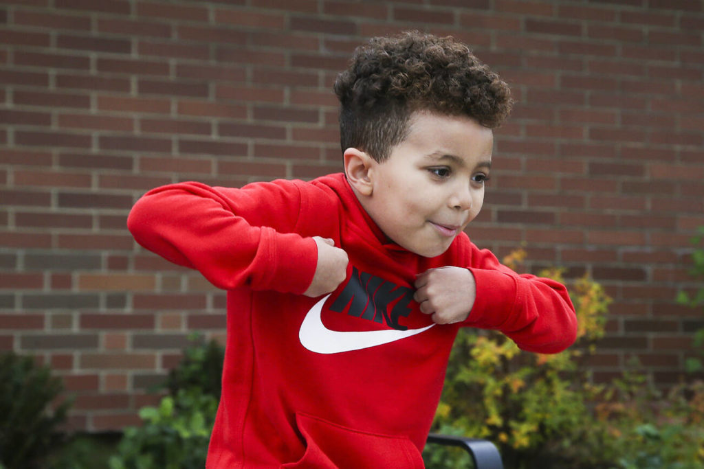 Robert, 5, imitates a turkey as he answers questions about Thanksgiving outside Mount Pilchuck Elementary on Monday in Lake Stevens. (Andy Bronson / The Herald)

