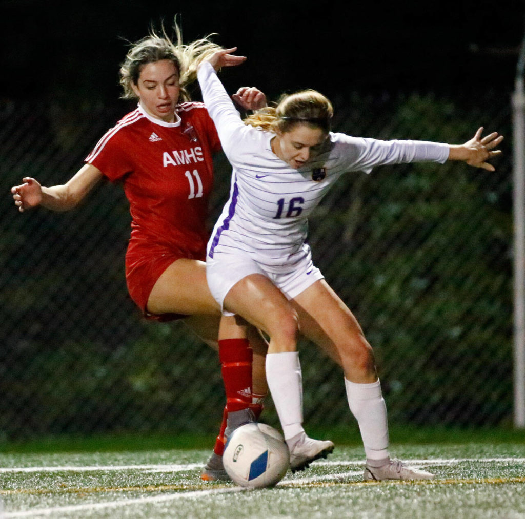 Archbishop Murphy’s Taylor Campbell, left, and Columbia River’s Kinzi Drake scrabble for the ball Friday night at Shoreline Stadium on November 19, 2021. The Wildcats advance to the state championships with the 2-1 win over the Rapids. (Kevin Clark / The Herald)
