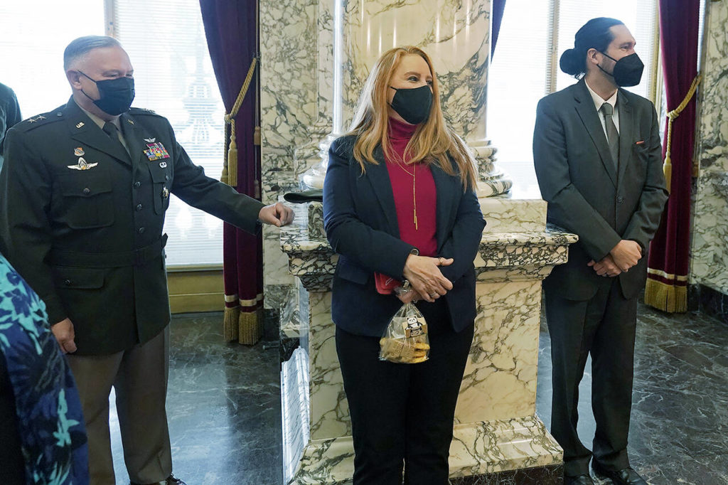 Former Washington Secretary of State Kim Wyman (center) listens as Steve Hobbs speaks after he was sworn in as her replacement Monday at the Capitol in Olympia. (AP Photo/Ted S. Warren)
