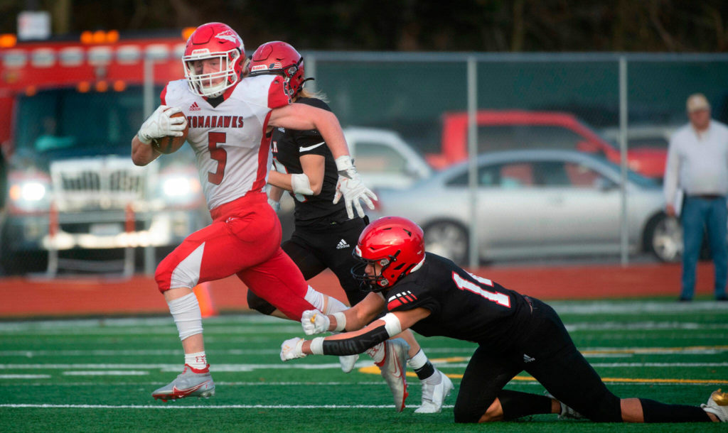 Marysville Pilchuck running back Dylan Carson breaks away from Yelm defensive back Marius Alone for a touchdown during a 3A football state quarterfinal game on Saturday, Nov. 20, 2021, at Yelm High School. Marysville Pilchuck won the game 39-21. (Tony Overman / The Olympian)
