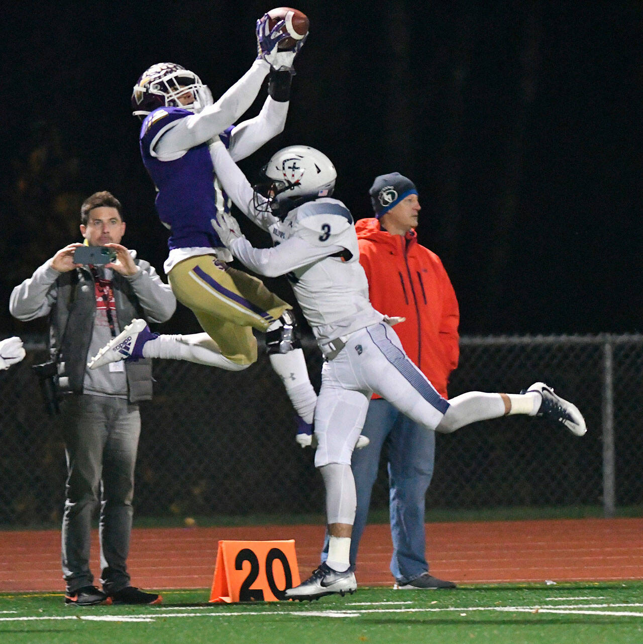 Lake Stevens’ Jayden Limar leaps for a catch over a Gonzaga Prep defender during a 4A state quarterfinal game on Nov. 20, 2021, at Lake Stevens High School. (John Gardner / Pro Action Image)