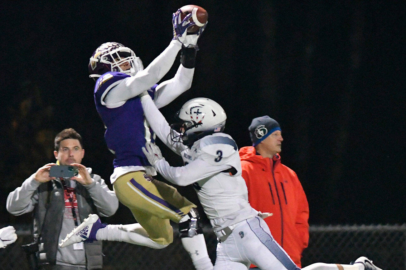 Lake Stevens' Jayden Limar leaps for a catch over a Gonzaga Prep defender during a 4A state quarterfinal game on Nov. 20, 2021, at Lake Stevens High School. (John Gardner / Pro Action Images)