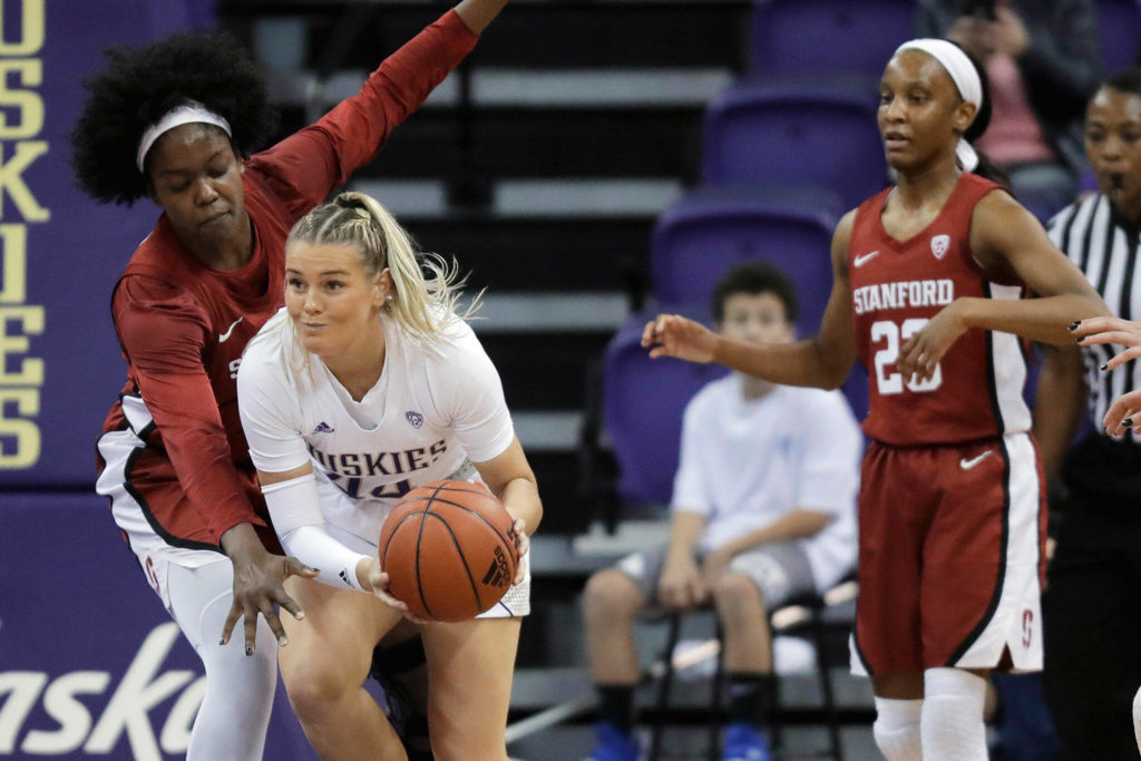 Washington guard Missy Petersonpasses under pressure from Stanford forward Nadia Fingall (left) during a game Jan. 31, 2020, in Seattle. (AP Photo/Ted S. Warren)
