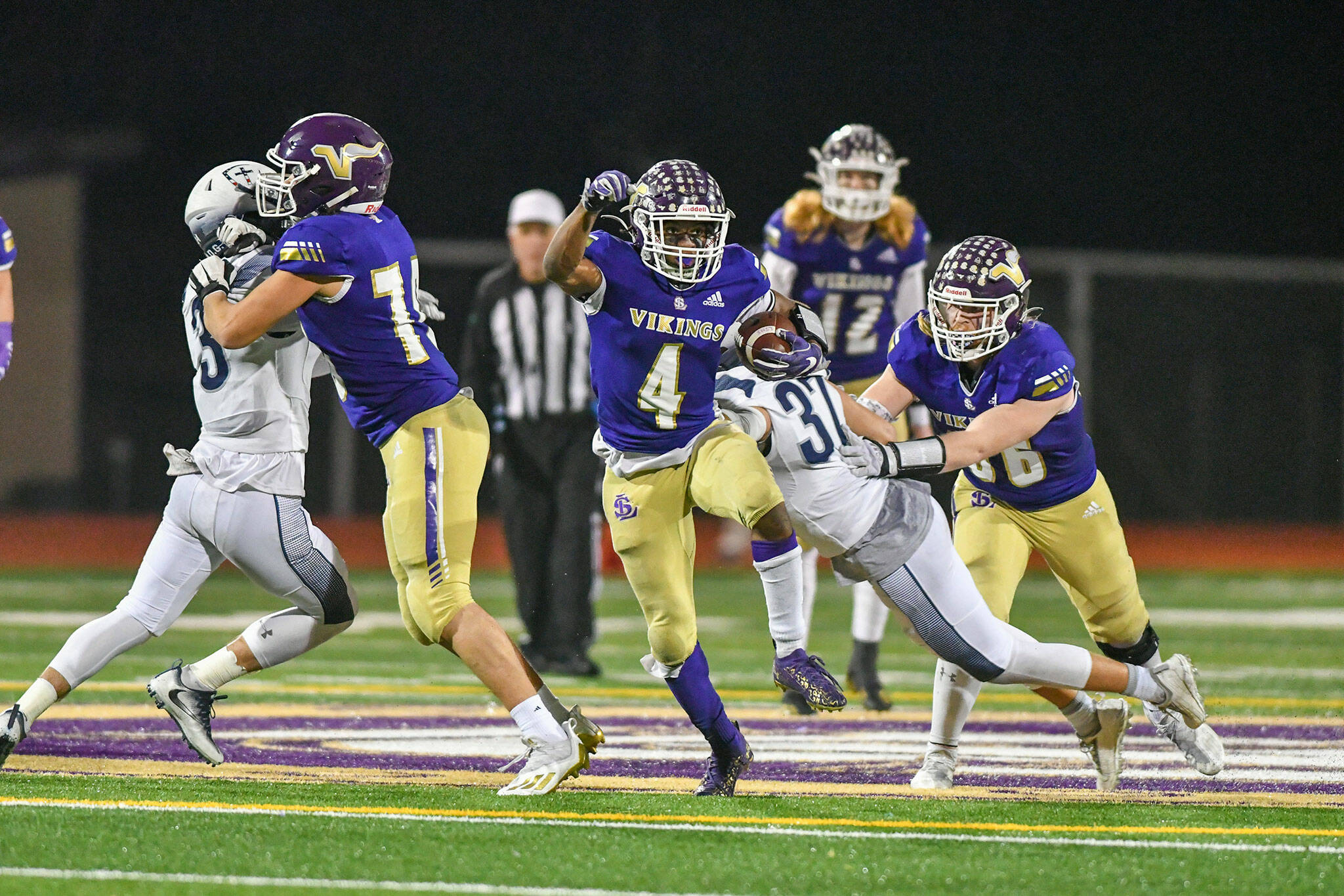 Lake Stevens’ Trayce Hanks eludes defenders during a 4A state quarterfinal game against Gonzaga Prep on Nov. 20 at Lake Stevens High School. (John Gardner / Pro Action Image)