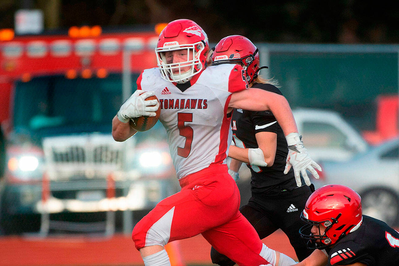 Marysville-Pilchuck running back Dylan Carson creaks away from Yelm defensive back Marius Alone for a touchdown run during Saturday afternoon’s 3A football state quarterfinal game at Yelm High School in Yelm, Washington, on Nov. 20, 2021. Marysville-Pilchuck won the game, 39-21.