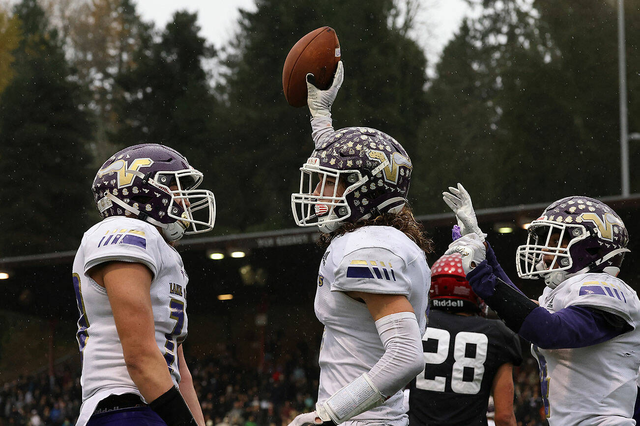 Lake Stevens' Drew Carter holds up the ball after scoring a touchdown to secure the win as Lake Stevens beat Eastlake 45-28 in a 4A state semi-final football game at Pop Keeney Stadium on Saturday, Nov. 27, 2021 in Bothell, Washington. (Andy Bronson / The Herald)