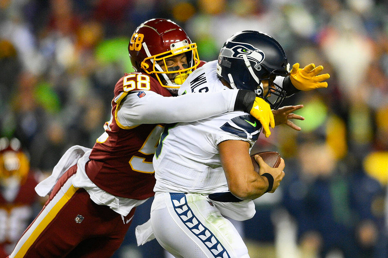 Seattle Seahawks quarterback Russell Wilson (3) is sacked by Washington Football Team defensive end Shaka Toney (58) during the second half of a game Monday in Landover, Md. (AP Photo/Nick Wass)