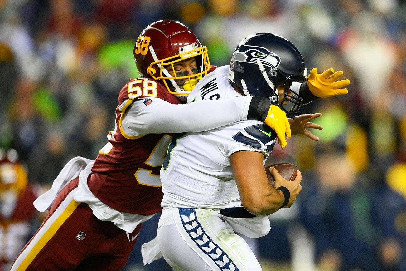 Seattle Seahawks quarterback Russell Wilson (3) is sacked by Washington Football Team defensive end Shaka Toney (58) during the second half of an NFL football game, Monday, Nov. 29, 2021, in Landover, Md. (AP Photo/Nick Wass)