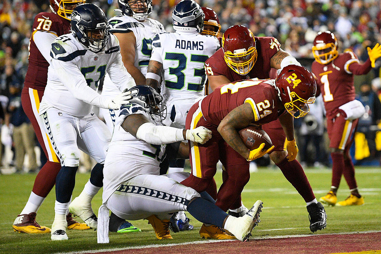 Washington Football Team running back Antonio Gibson (24) scores on a two-point conversion against the Seattle Seahawks during the second half of an NFL football game, Monday, Nov. 29, 2021, in Landover, Md. (AP Photo/Nick Wass)