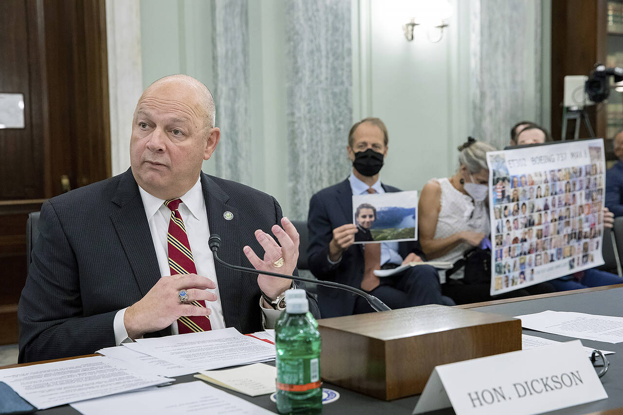 FAA Administrator Steve Dickson speaks to lawmakers as Michael Stumo, holding a photo of his daughter Samya Rose Stumo, and his wife Nadia Milleron, sit behind him during a Senate Committee on Commerce, Science, and Transportation hearing on the implementation of aviation safety reform at the US Capitol in Washington on Nov. 3. Samya Stumo was among those killed in a Boeing 737 Max 8 crash in 2019. (AP Photo/Amanda Andrade-Rhoades, file)