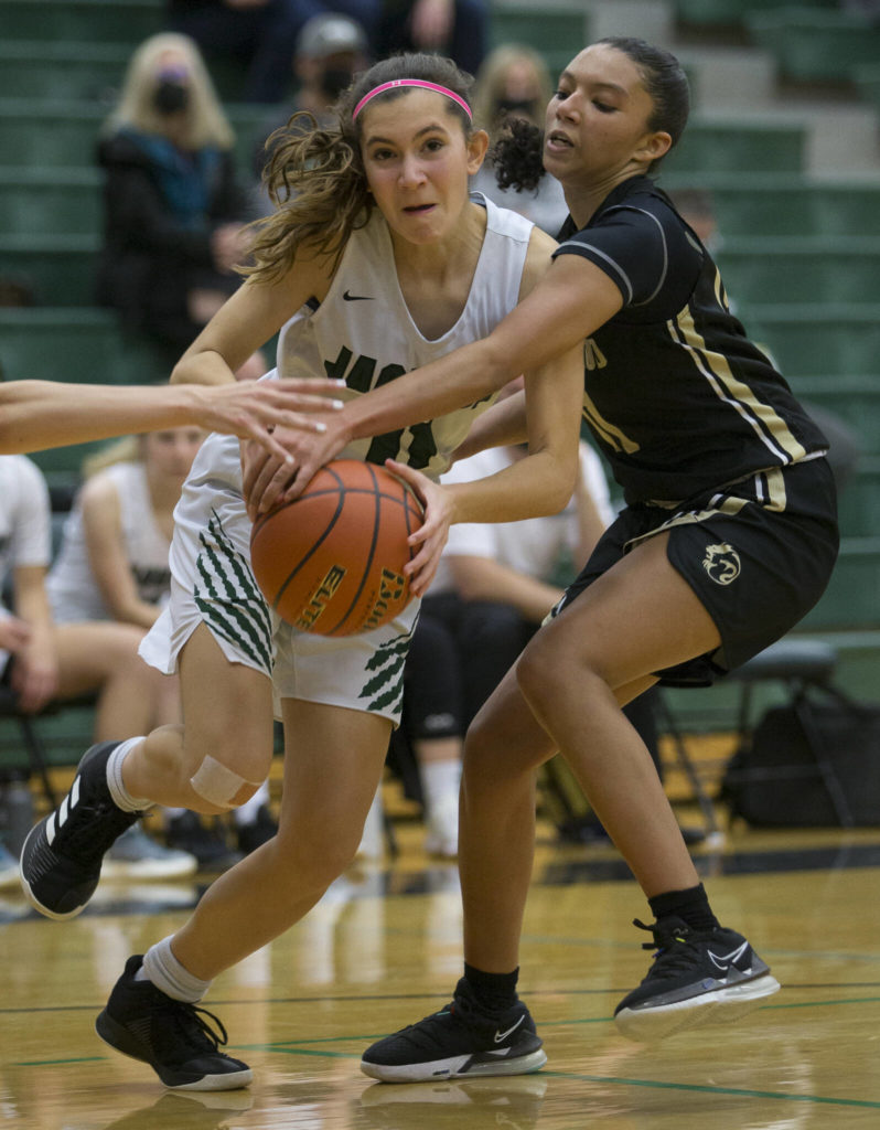 Lynnwood’s Mia Jones reaches out to block Jackson’s Quinlyn McAuliffe during the game on Tuesday in Everett. (Olivia Vanni / The Herald)
