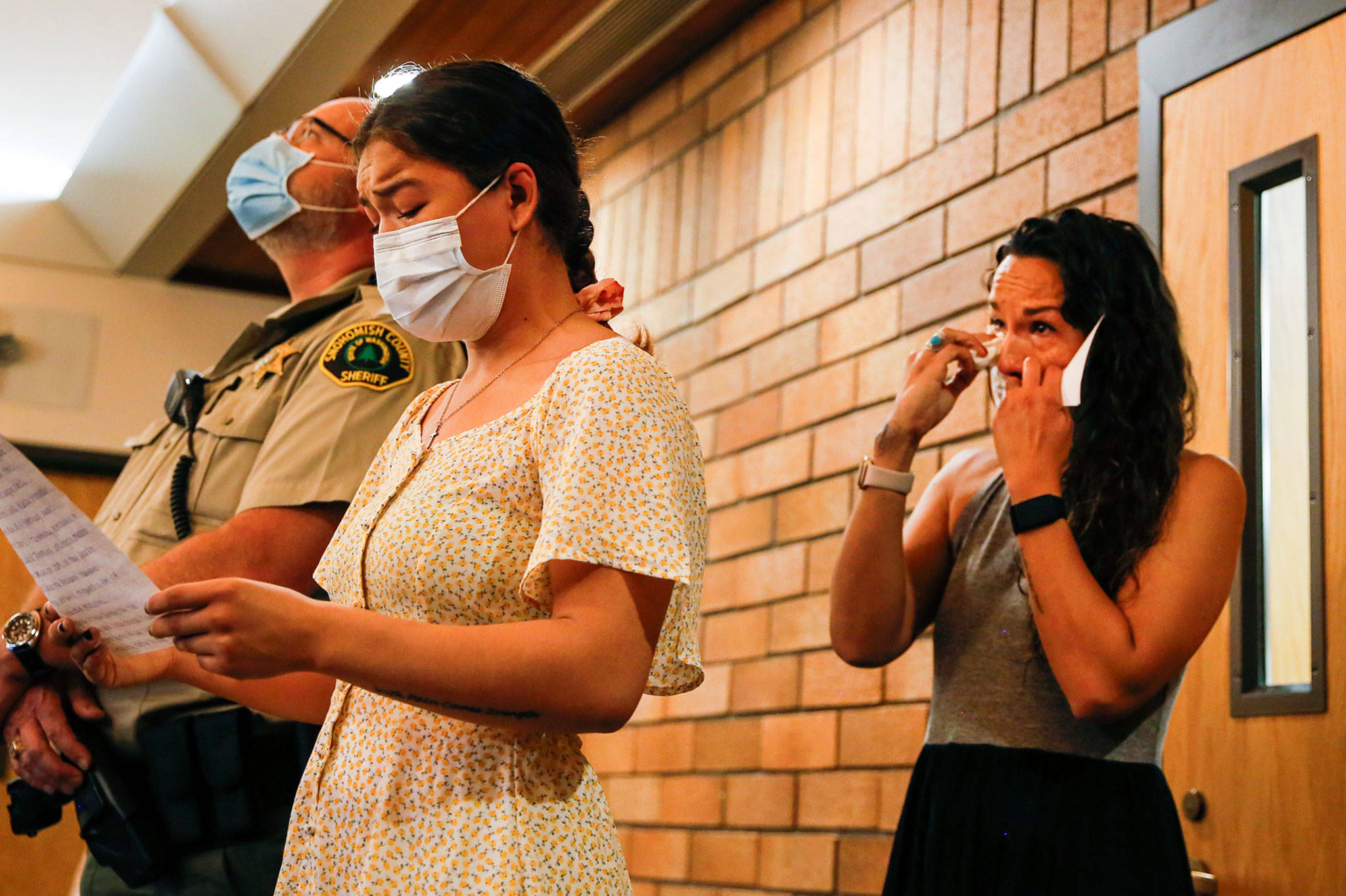 Joessie Gonzales (left) reads a statement with her mother, Jamie Gonzales, during the sentencing of Jeremy Pidgeon at Snohomish County District Court in Monroe on June 23. (Kevin Clark / The Herald)