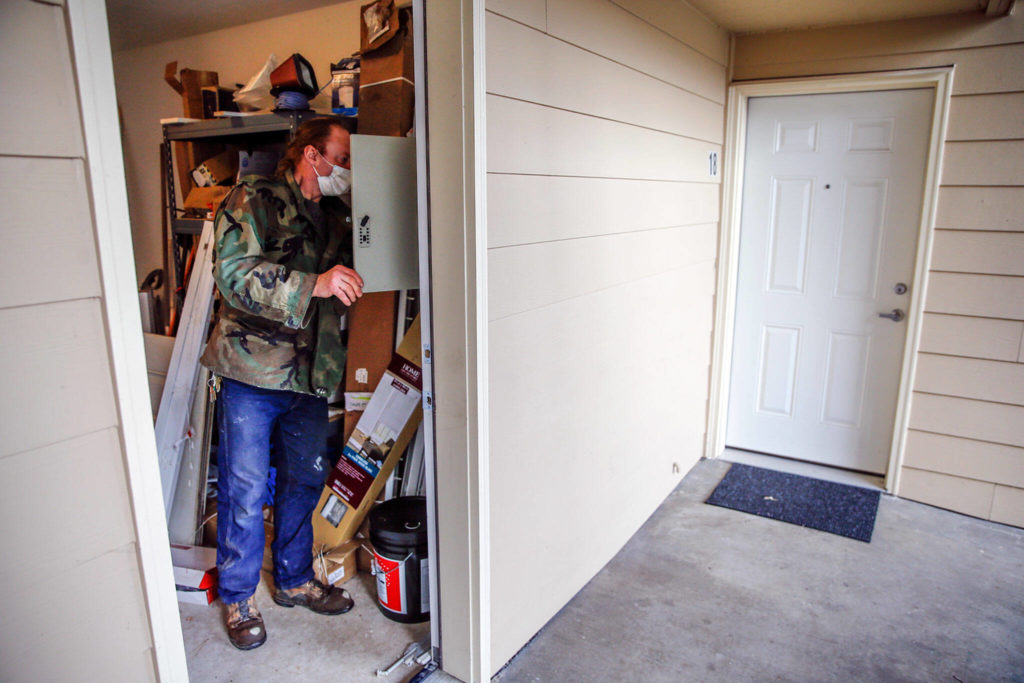 Dennis Willard gathers keys for his next repair in Monroe on Oct. 29. (Kevin Clark / The Herald)
