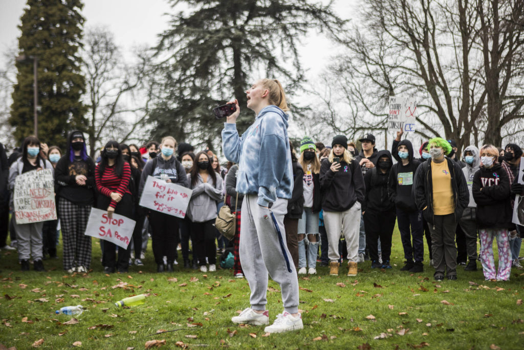 Nicole Johnson, a student at Everett High School, tells her story of sexual assault and demands change from the school district during a gathering at Clark Park on Dec. 16 in Everett. (Olivia Vanni / The Herald)
