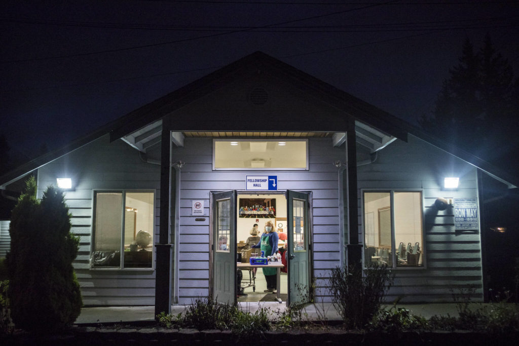 Volunteers open the doors Nov. 30 for Faith Lutheran Church’s food service night as part of the Everett Hot Meals Coalition. (Olivia Vanni / The Herald) 

