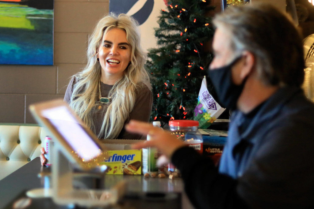 Tawni Dillion (left) talks with Joe Kutz on Friday afternoon at Brews Almighty in Everett. (Kevin Clark / The Herald)
