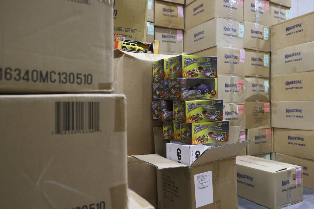 Toys are unboxed at the Everett Boys Girls Club Christmas House on Monday. (Andy Bronson / The Herald)
