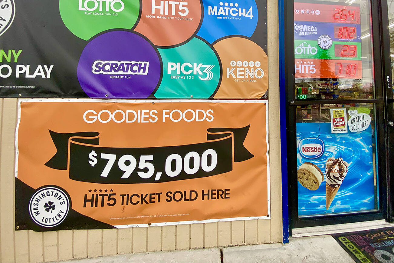 A banner outside the door of Goodies in Mountlake Terrace says, “$795,000 Hit 5 ticket sold here.” (Andrea Brown / The Herald) 20211201