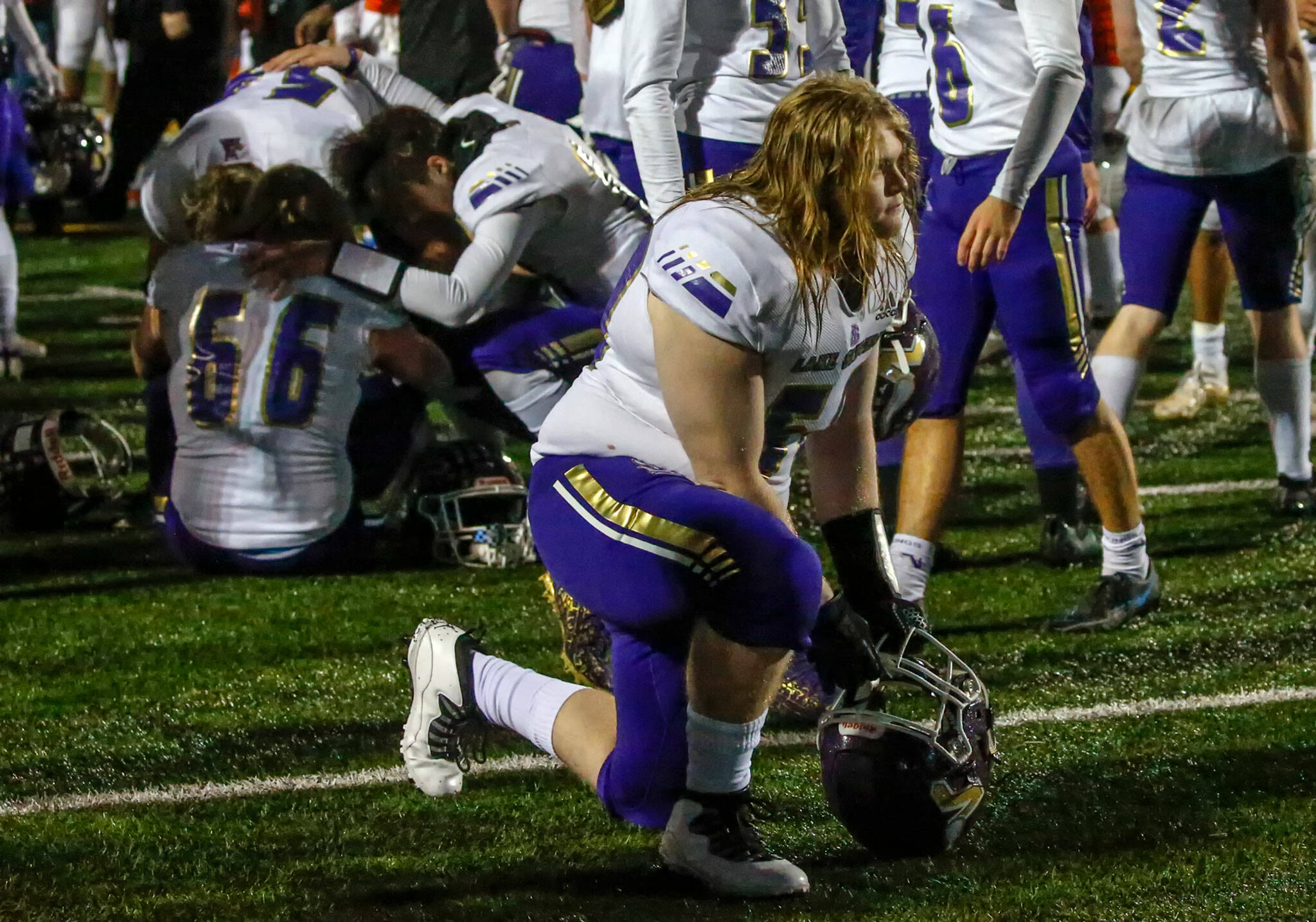 Lake Stevens players react to their 44-7 loss to Graham-Kapowsin in Saturday night’s Class 4A state championship game. (Kevin Clark / The Herald)