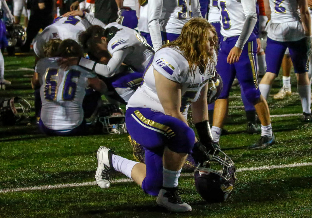Lake Stevens players react to their 44-7 loss to Graham-Kapowsin in Saturday night’s Class 4A state championship game. (Kevin Clark / The Herald)
