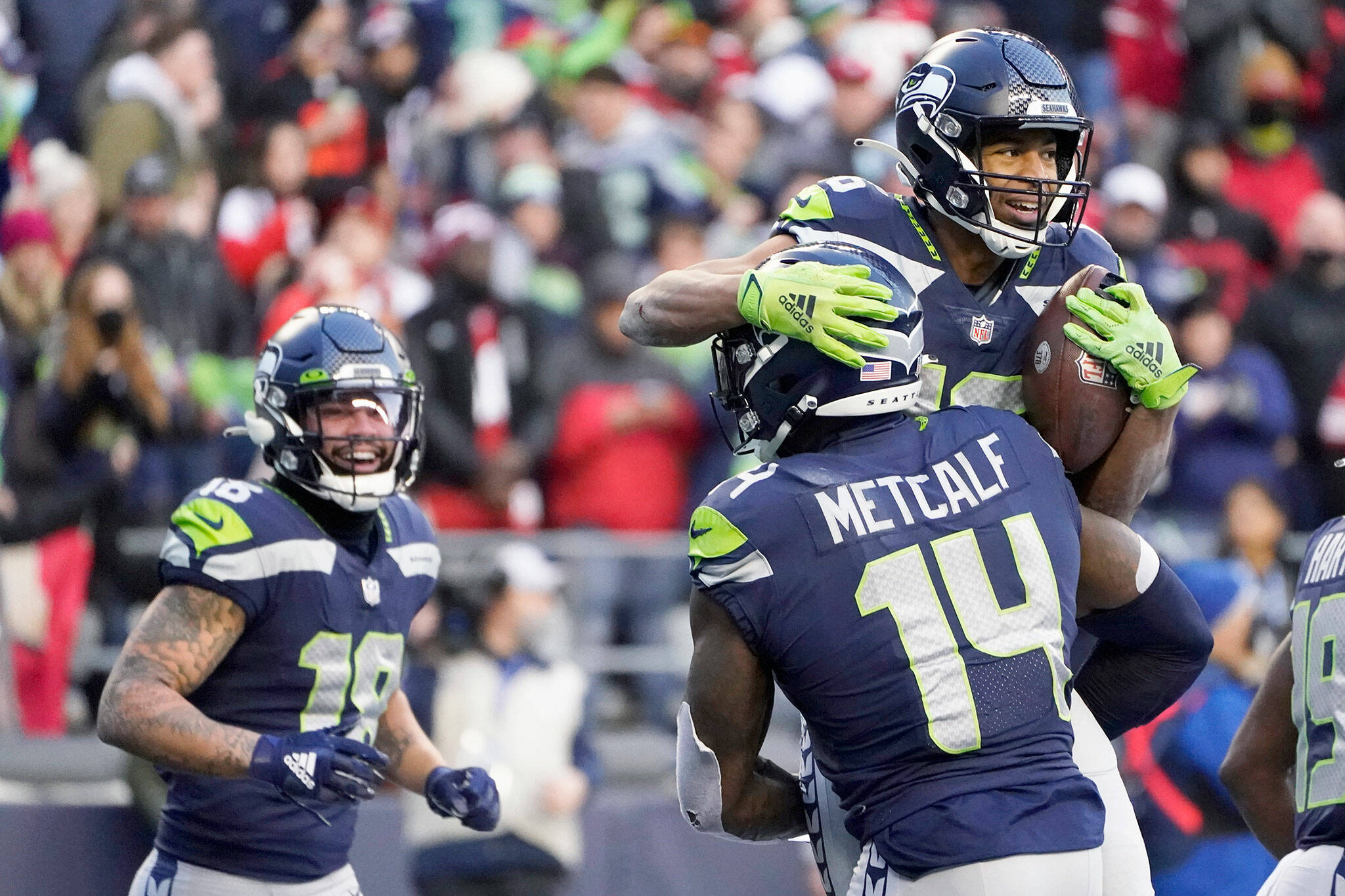 Seattle Seahawks wide receiver Tyler Lockett, upper right, is lifted by wide receiver DK Metcalf (14) after scoring a touchdown against the San Francisco 49ers during the second half of a game Sunday at Lumen Field in Seattle. (AP Photo/Elaine Thompson)
