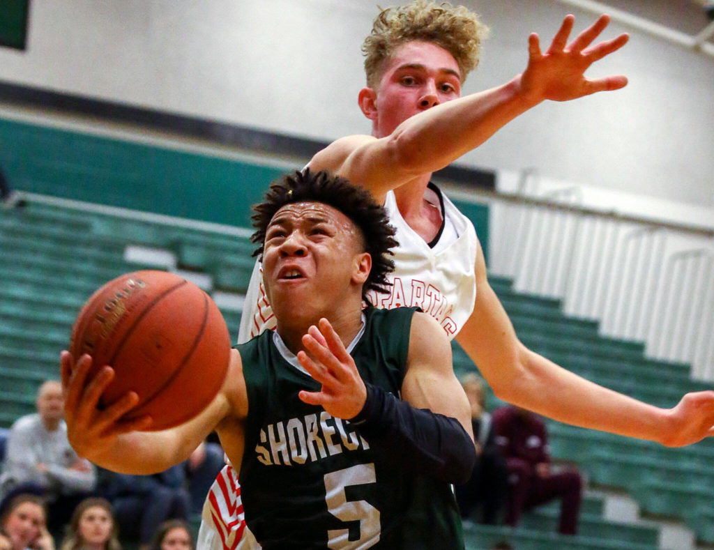Shorecrest’s Elijah Johnson attempts a shot the Stanwood’s Kaeden McGlothin trailing Wednesday evening at Jackson High School in Mill Creek on February 19, 2020. (Kevin Clark / The Herald)
