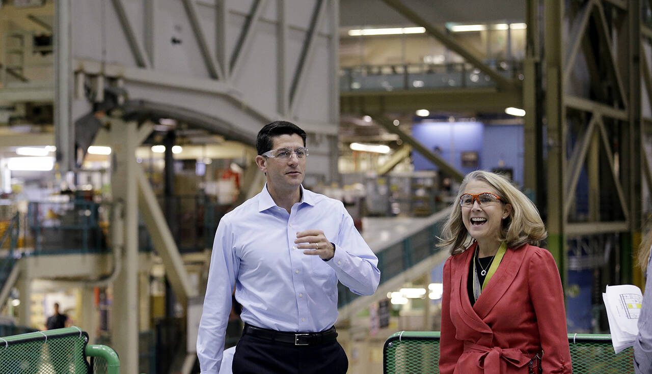 In this August 2017 photo, former House Speaker Paul Ryan (left) walks with Elizabeth Lund, then vice president and general manager of Boeing’s 777 program, during a tour of Boeing’s Everett plant. (AP Photo/Elaine Thompson, file)