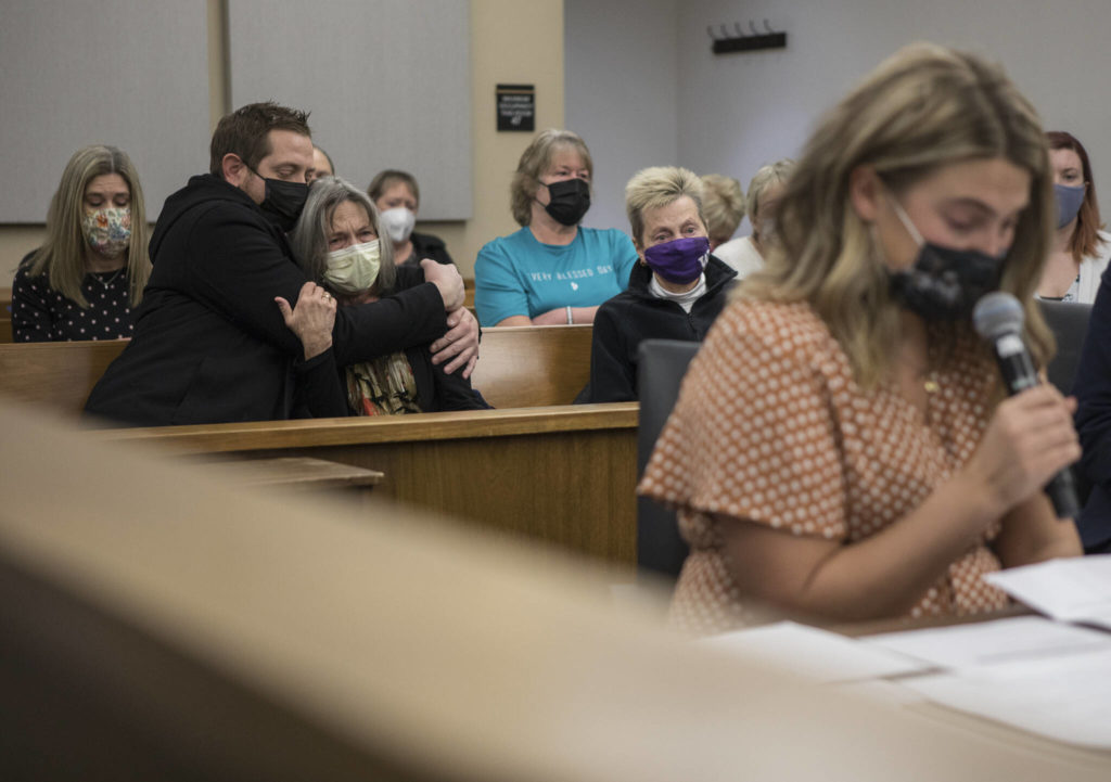Family and friends of the Benzel family listen while Breanne Benzel, daughter of Howard Benzel, reads her victim statement to the court during Frank Walton’s sentencing hearing Monday in Everett. (Olivia Vanni / The Herald)
