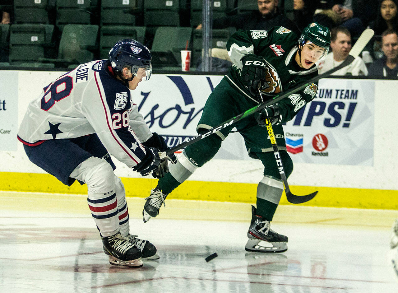 Everett Silvertips’ Olen Zellweger (right) takes a shot during a game against the Tri-City Americans on Sept. 20, 2019 in Everett. Zellweger is one of three Silvertips selected to play in the upcoming World Junior Hockey Championships. (Olivia Vanni / The Herald)