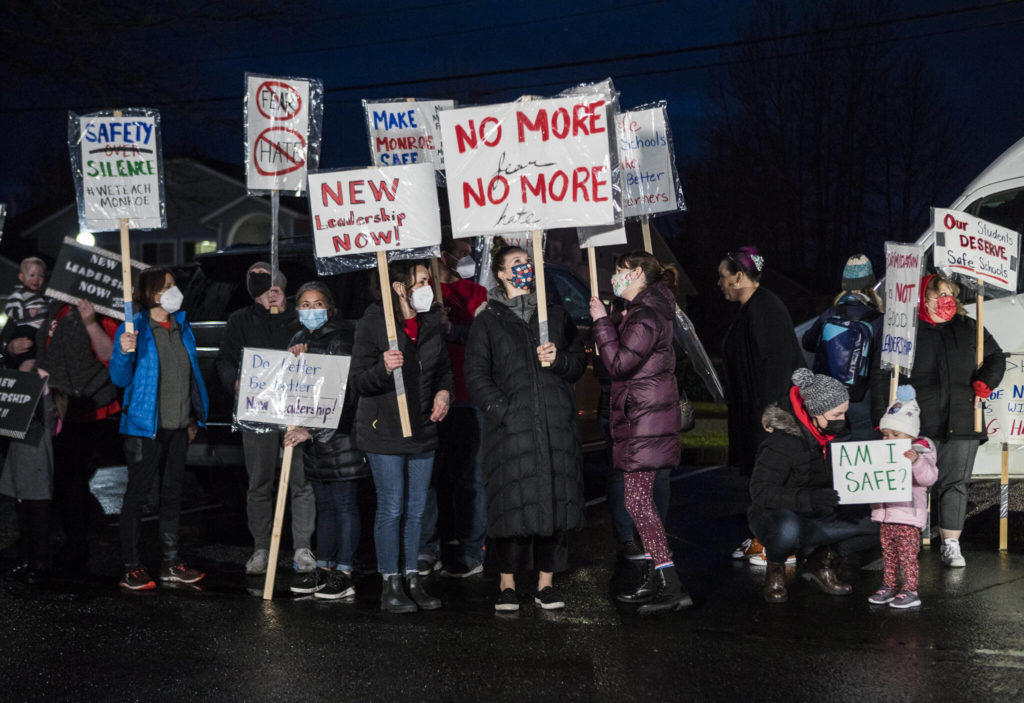 Teachers, parents and students gather on Monday in front of the Monroe School District building for a rally demanding the district address harassment and bullying problems. (Olivia Vanni / The Herald)
