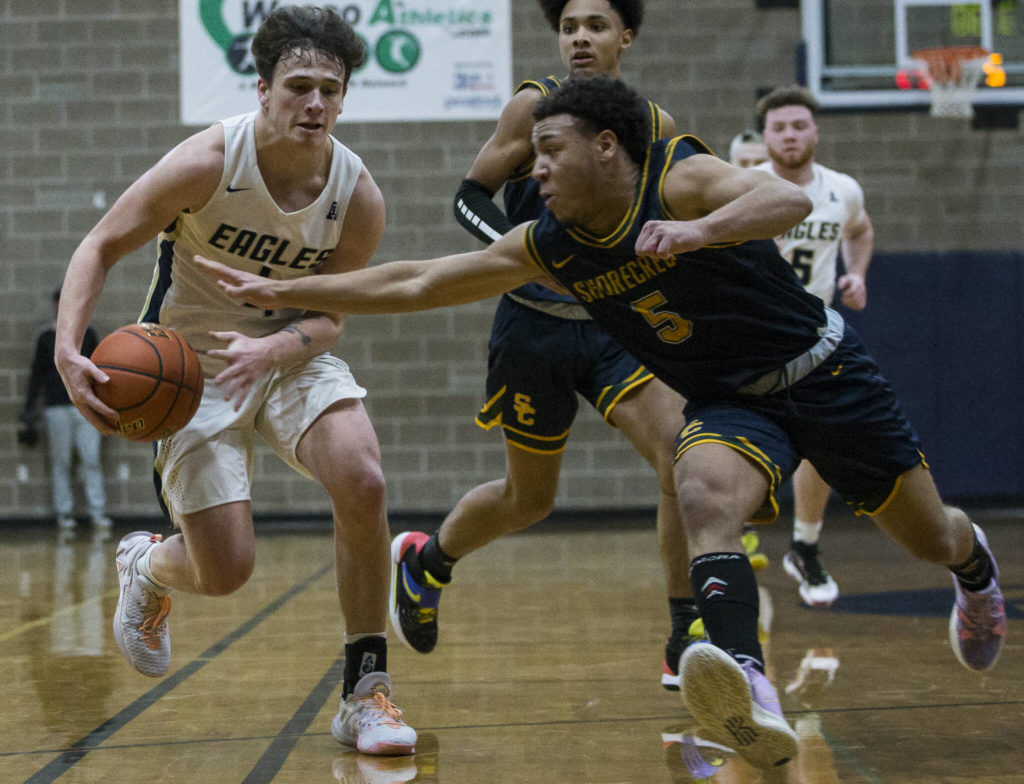 Shorecrest’s Elijah Johnson tries to steal the ball from Arlington’s Grayson Falk during the game on Tuesday, Dec. 14, 2021 in Arlington, Wa. (Olivia Vanni / The Herald)
